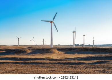 Wind power plants in desert at sunset - Powered by Shutterstock