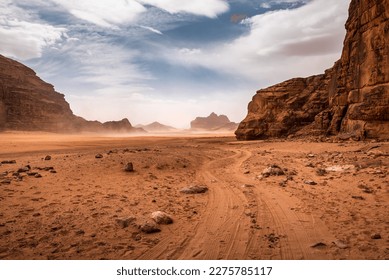 The wind raises the dust in Wadi Rum, Sahara or Arabian desert - Powered by Shutterstock