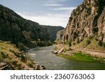 Wind River Mountain Range and Canyons in the northern Wyoming country, during summer with a flowing river between canyons, with a film-like and cinematic color grade.