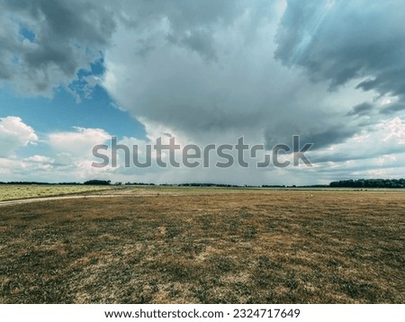 Wind Swept Horizon: Dramatic Sky over Rural Prairie Landscape