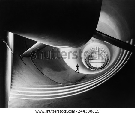 Wind tunnel at Langley Aeronautical Laboratory in the 1940s, to study the effects of air moving past solid objects. Photo by William P. Taub, NASA photographer, who is also pictured in the image.