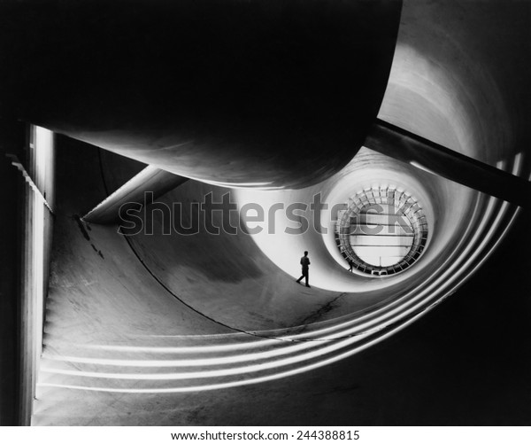 Wind tunnel at Langley Aeronautical Laboratory in\
the 1940s, to study the effects of air moving past solid objects.\
Photo by William P. Taub, NASA photographer, who is also pictured\
in the image.