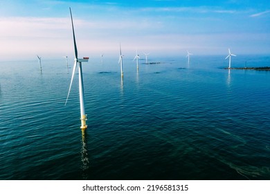 Wind Turbine. Aerial View Of Wind Turbines Or Windmills Farm Field In Blue Sea In Finland. Sustainable Green Clean Energy.