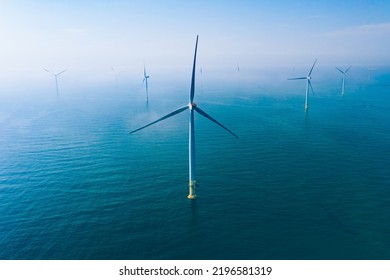 Wind turbine. Aerial view of wind turbines or windmills farm field in blue sea in Finland. Sustainable green clean energy. - Shutterstock ID 2196581319