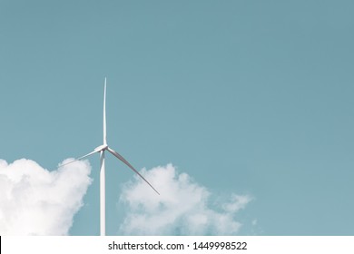 Wind Turbine Alone Against Sky With Negative Space.  Close Up Wind Turbine Against Blue Sky With Idyllic White Clouds, Wind Power Concept With Copy Space. Technology In Nature Environment No People.