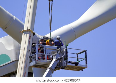 Wind turbine being repaired, manual workers maintenance