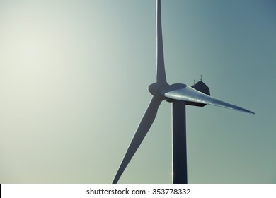 Wind turbine close up view with blue sky background