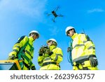 Wind turbine farm engineer, green energy engineering, eco-friendly electricity power technology industry. Technician engineer team working maintenance wind turbine generator with using survey drone.