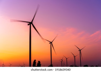 wind turbine farm with motion blurr at sunset