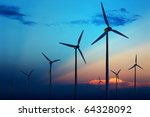 Wind turbine farm with rays of light at sunset