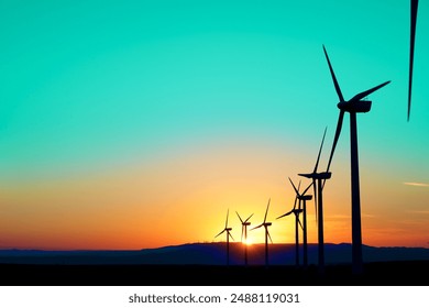 Wind turbine generators for green electrical energy production at sunrise - Powered by Shutterstock