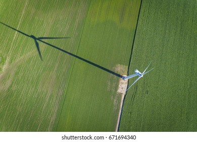 Wind Turbine In A Green Field, Top Aerial View