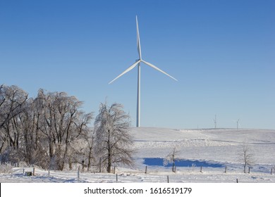 Wind turbine on a snow covered hilltop. - Powered by Shutterstock