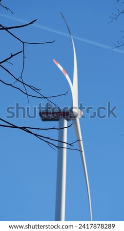 Wind turbine out of Fokus in forest