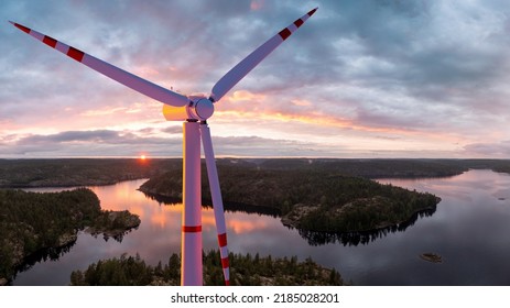 Wind Turbine. Windmill Above Trees And River. Wind Turbine On Sunset. Turbine For Generating Energy From Wind. Renewable Energy Sources. Windmill From Birds Eye View. Caring For Environment. 