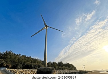 WIND TURBINE wind-mill generator; wind-driven at pebbleand sand beach