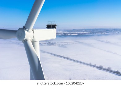 Wind Turbine In Winter With Snow And Fog Aerial View And Close-up View