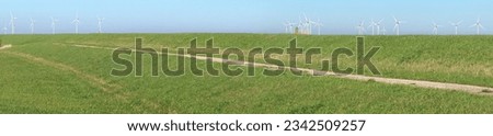 Wind turbines behind a sea defence dike along the Eastern Scheldt estuary in Zeeland province, the Netherlands