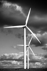 Wind Turbines With A Cloudy Sky In Black And White