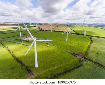 Wind Turbines For Electrical Energy Generation - Power Station For Clean Energy Production From Wind In UK Countryside - Aerial View Of A Wind Farm In England