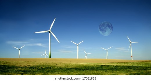 Wind turbines farm with full moon. Alternative energy source. - Powered by Shutterstock