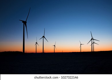 Wind Turbines Farm At Sunset