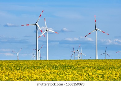 Wind turbines and a flowering canola field seen in Germany