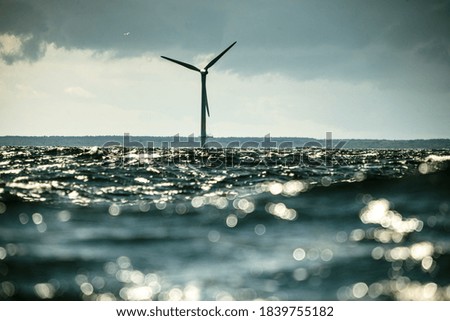 Wind turbines generator farm for renewable sustainable and alternative energy production along coast baltic sea near Denmark. Eco power, ecology.