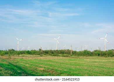 Wind Turbines Generators On Green Meadow. Source Of Alternative Electricity. Ecological Renewable Power Sources.