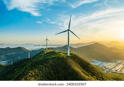 Wind turbines and green mountain nature landscape near the sea.  Green energy concept.  aerial view. - Powered by Shutterstock