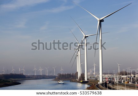 Wind turbines near canal Hartel in industrial area Europoort of Rotterdam in the Netherlands