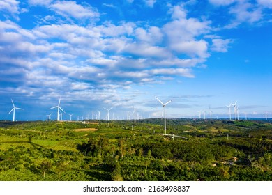 Wind Turbines On Beautiful Sunny Mountain And Forest Landscape. Green Ecological Power Energy Generation. Wind Farm Eco Field To Reduce Global Warming And Climate Change And Pollution