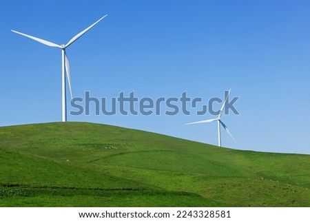 Wind turbines on the green meadow, renewable energy, sustainable lifestyle