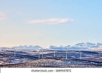 Wind turbines out in Swedish mountains nature outside Kiruna. Sweden's highest mountain Kebnekaise can be obscured in the background among several mountain peaks. - Powered by Shutterstock