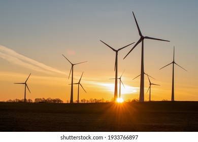 wind turbines in the rising sun - Shutterstock ID 1933766897