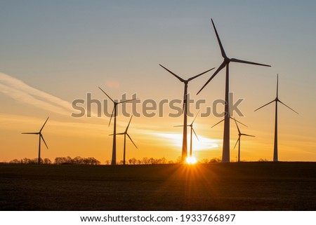 wind turbines in the rising sun