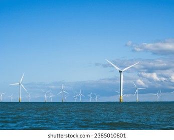 Wind turbines at sea with blue sky - Shutterstock ID 2385010801