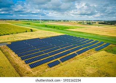 Wind Turbines And Solar Panel On Field. Alternative Energy In Poland, Aerial View Of Nature