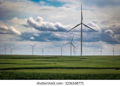 WInd turbines stand in cornfields and storm clouds on the horizon near Stuart, Iowa. - Shutterstock ID 2236168771