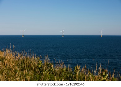 Wind turbines stand off the shores of Block Island, Rhode Island, USA.