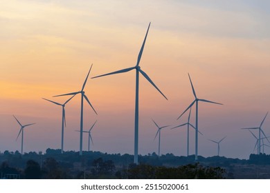 Wind turbines at sunset, an alternative energy source from wind that can produce electricity both day and night. - Powered by Shutterstock