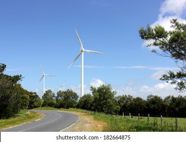 Wind turbines with trees in foreground in country Australia