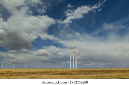 Wind Turbines Windmill Energy Farm In West Texas Plains Under A Blue Sky