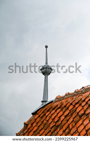 Wind vane, weather sign, weathercock, metal lace on the roof with roof tiles in the Dracula Castle, Bran Castle, Törzburg or Castelul Bran in Bran Village, Transylvania in Romania