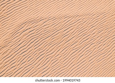 Wind Wave Vortices In Sand Background From Aerial Top View.