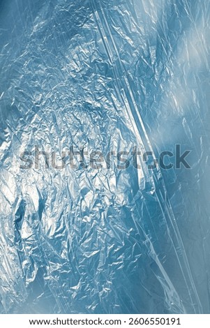 The wind whispers across the delicate surface of the nylon, lifting and folding it into endless waves of motion. It plays like an invisible artist, sculpting creases and curves with each passing gust.
