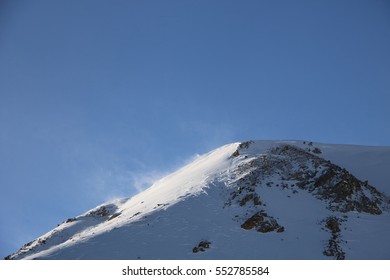 Windblown Snowy Mountain Peak with large copy space - Powered by Shutterstock