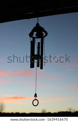 windchime in the sunset. pink clouds