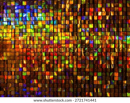 a wind-driven shimmer wall backdrop featuring square, iridescent, holographic sequins. These panels are a popular choice for event decorations due to their dynamic, light-reflecting properties