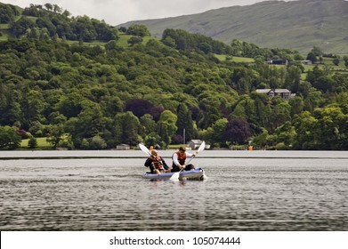 WINDERMERE, UK - JUN 9: Two Men Kayaking In Windermere On June 9, 2012. Canoeing And Kayaking Is One Of The Most Popular Activities In The Lake District